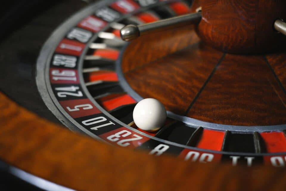 Close-up of a roulette wheel with a white ball resting on a number