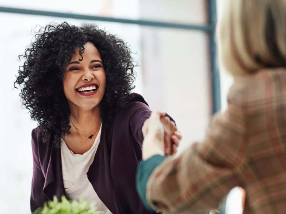Shutterstock Bought 130924 Young Woman Smiling And Shaking Hand