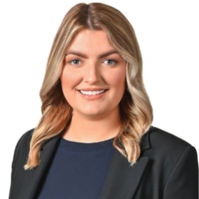 Young blonde woman in a suit smiling