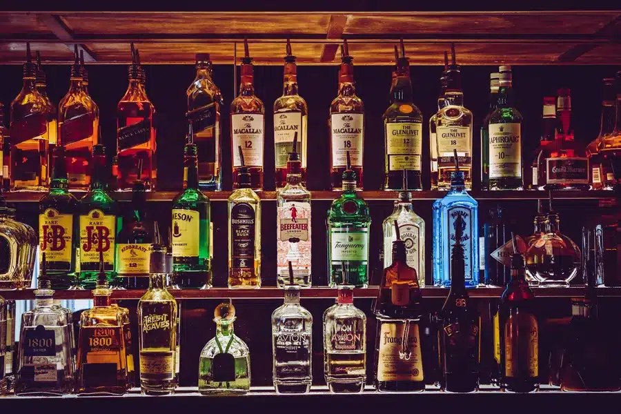 Shelves in a bar full of bottles of spirits