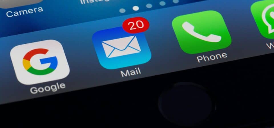 A close-up of a smartphone screen showing the Mail app with 20 unread messages, alongside Google and Phone app icons.