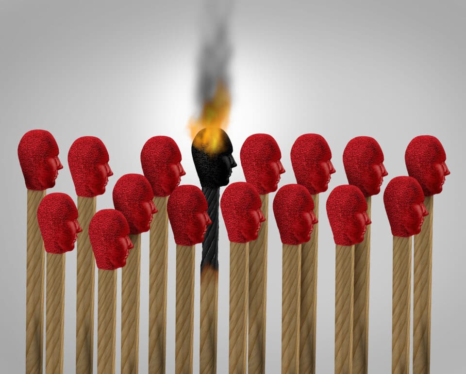 Matches with head that look like people. One match has been struck and is alight.