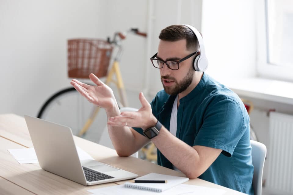 Person working from home talking on a laptop