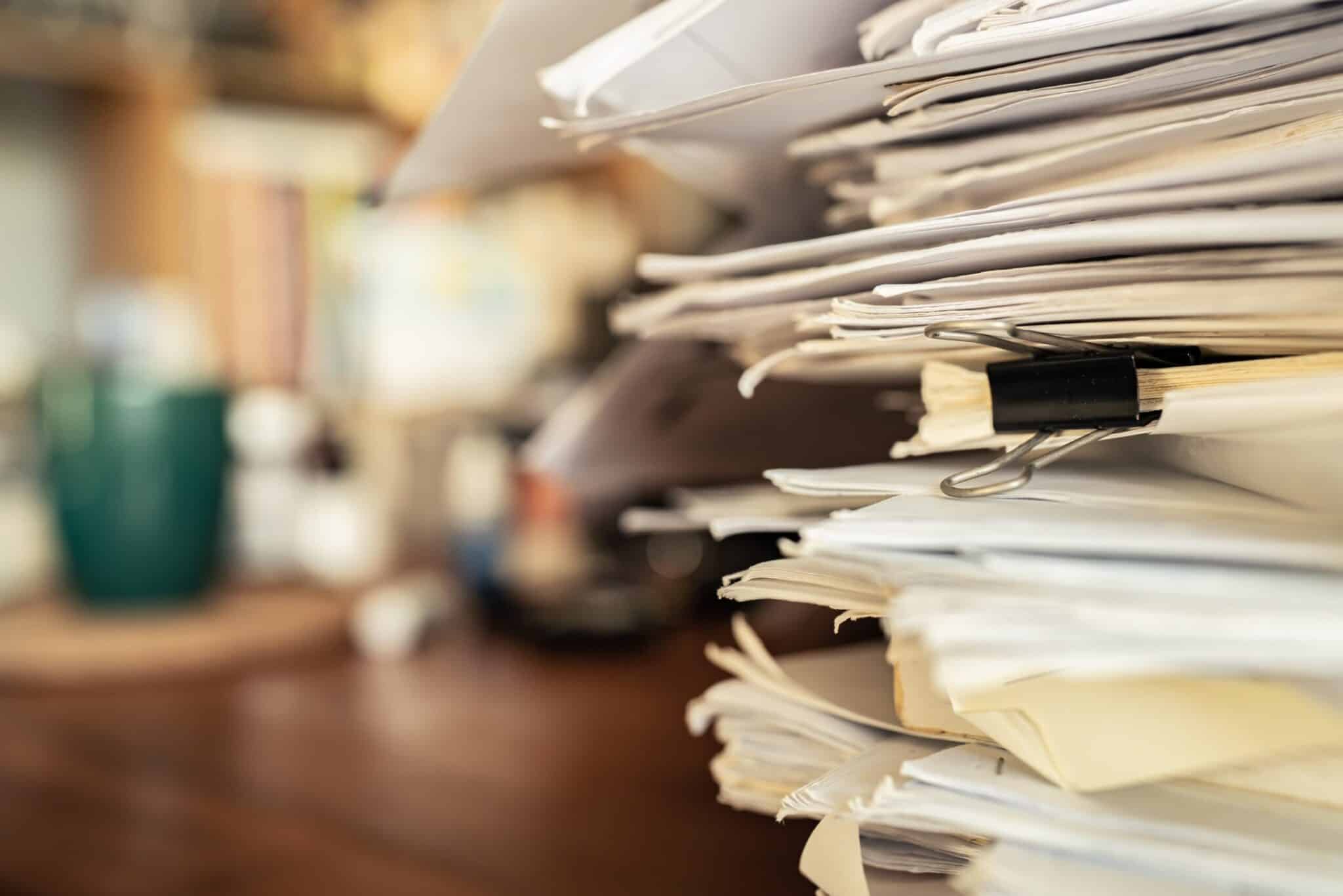 Massive pile of paperwork on a desk