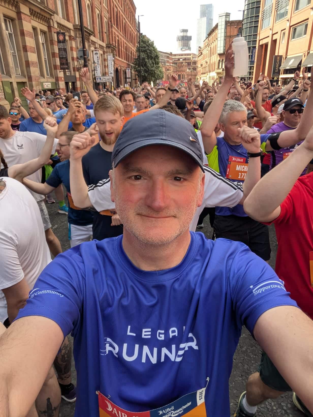 Mark Evans at the start of a run, wearing a blue ‘Legal Runner’ top, with other runners behind him.