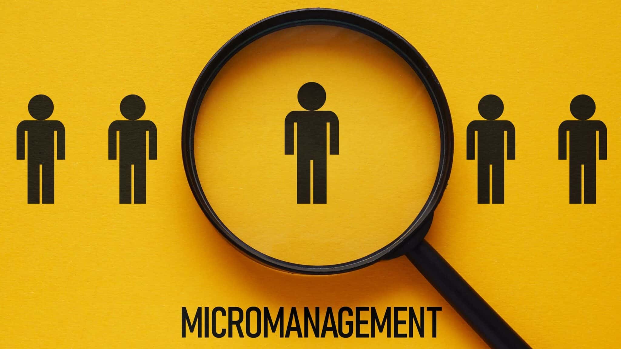 Illustration of a magnifying glass focusing on one person among others, representing micromanagement.