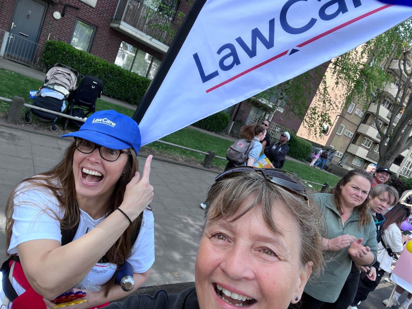 Rose and Elizabeth from LawCare waiting to cheer the runners on. Complete with a LawCare rucksack flag.