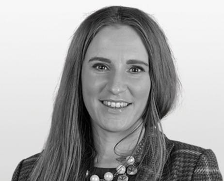 Black and white photo of Justine. Headshot of woman with long blonde hair.