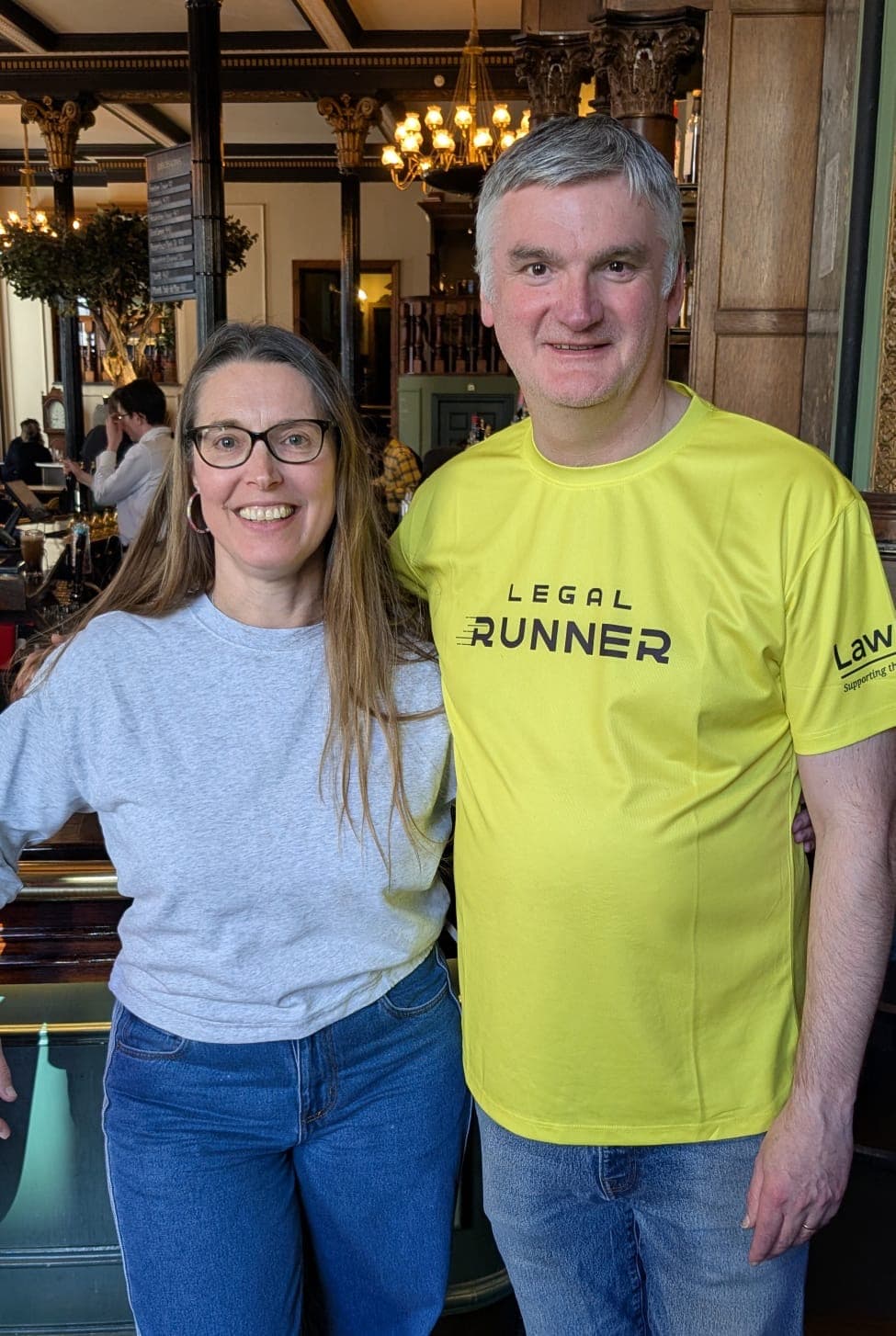 Mark wearing a yellow Legal Runner t-shirt with Rose in a pre-race meet up at a pub.